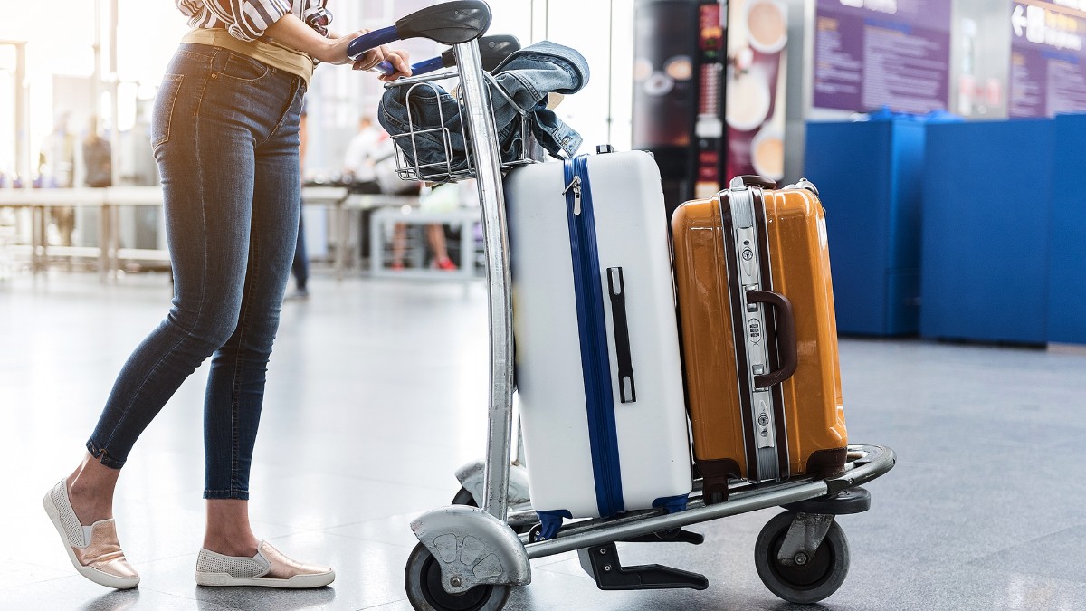 mujer con maletas en aeropuerto